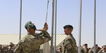 Danish soldiers raising the flag in Afghanistan during their deployment