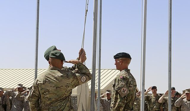 Danish soldiers raising the flag in Afghanistan during their deployment