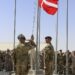 Danish soldiers raising the flag in Afghanistan during their deployment