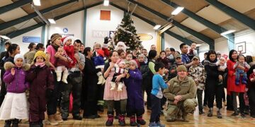 A community gathering of children and families in Greenland during a festive event, illustrating the youth and local life in Nuuk