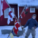 Legendary explorer Jens Kjeldsen holding flags during a protest in Nuuk, Greenland