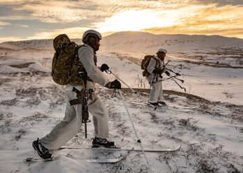 Royal Marines Surveillance and Reconnaissance Squadron conducting live firing tactical training in the Arctic, representing the elite NATO forces required for Greenland defense