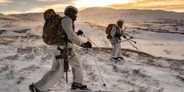Royal Marines Surveillance and Reconnaissance Squadron conducting live firing tactical training in the Arctic, representing the elite NATO forces required for Greenland defense