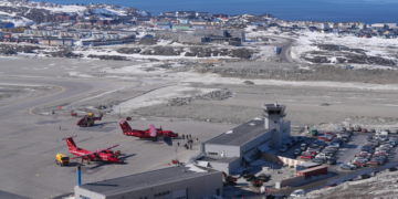 Aerial view of the new Nuuk International Airport terminal and runway in winter, Greenland